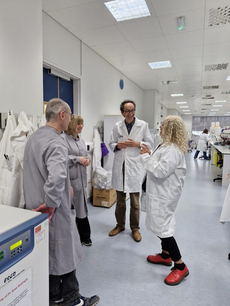 Kim Johnson MP speaking with researchers in the lab at The Pandemic Institute